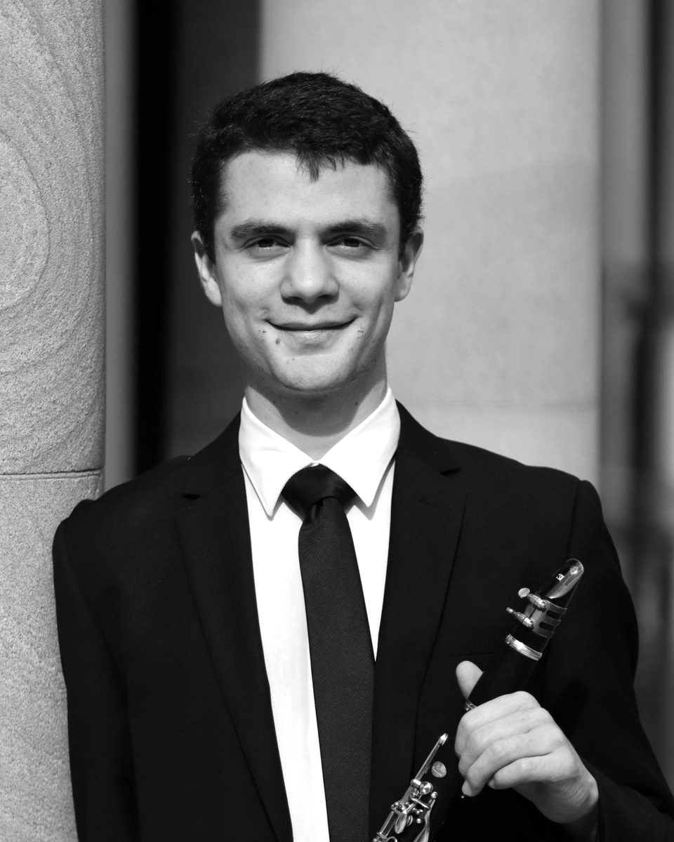 Nathanael Duffy in a black suit, holding his clarinet